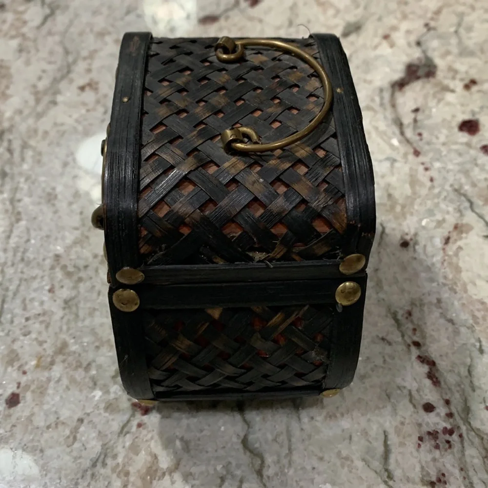 Set of two wooden boxes, rattan? They each have a slide lock, and can be nested.